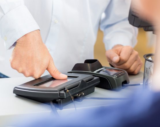 man pressing thumb on fingerprint scanner